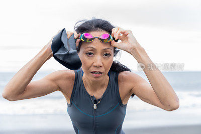 Triathlete woman coming out from sea